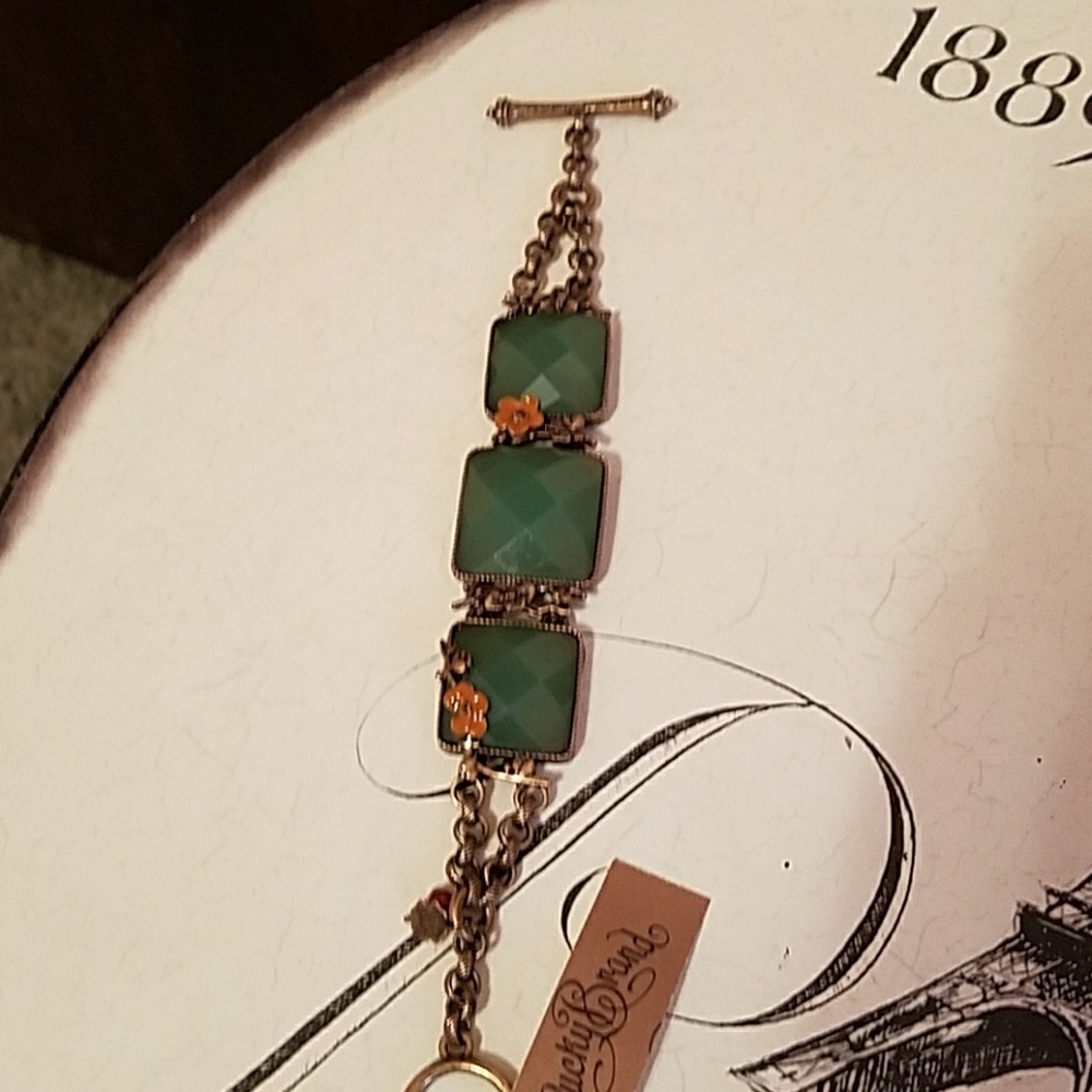 Brass bracelet with green stones.